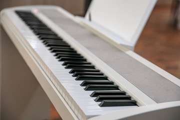 Fototapeta na wymiar White synthesizer keys foreground sharpness