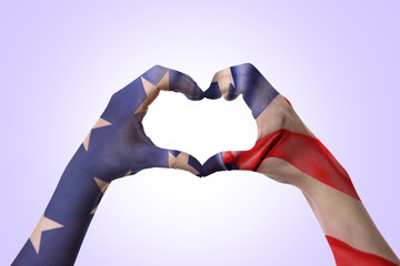 Hands of woman making heart shape on white background