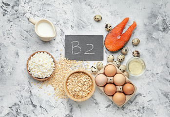 Healthy products rich in vitamin B2 on grey background