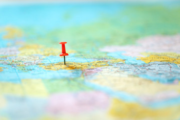 Fototapeta na wymiar pushpin on world map with blurry background