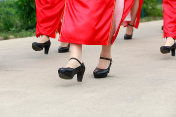 red cheongsam ladies in the park