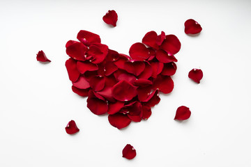 Heart shaped red rose petals. Greeting card for the holiday.