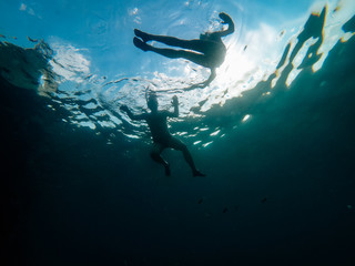 Fototapeta na wymiar Underwater photo of couple snorkeling in a sea