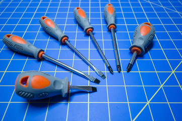 Rotating of Screwdrivers on Blue Stationary Mat
