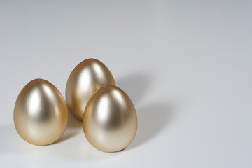 Golden easter eggs on the white table.