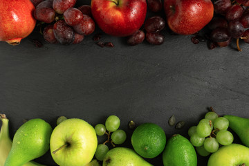 fruits background green and red color set, dark stone slake plate with copy space. Flat lay top view. Summer abstract creative trendy fresh concept.