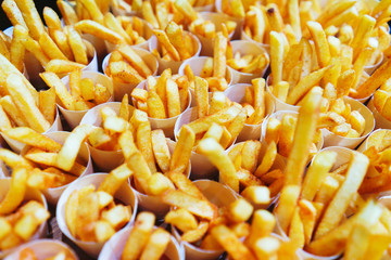 French fries in paper cups. Catering and guest meals during the event. Quick mini snacks in a special beautiful dish. Canapes and light meals, tapas on the table in the restaurant.