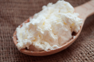 Spoon cottage cheese. Nutrition on a diet. Keto diet. Farm dairy products. Healthy breakfast.