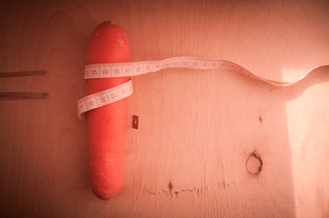 Carrots as a symbol of a slim figure. Healthy lifestyle. Lose weight by the summer. Proper...