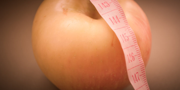 Apple and measuring tape. Healthy lifestyle. Slim for the summer. proper nutrition. HLS. Apple shape type.