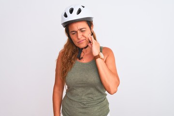 Middle age mature cyclist woman wearing safety helmet over isolated background touching mouth with hand with painful expression because of toothache or dental illness on teeth. Dentist concept.
