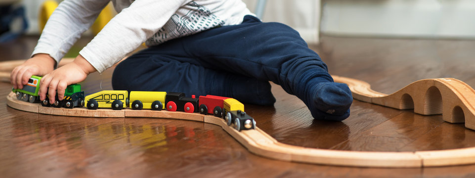 Child Playing With Train Toy 