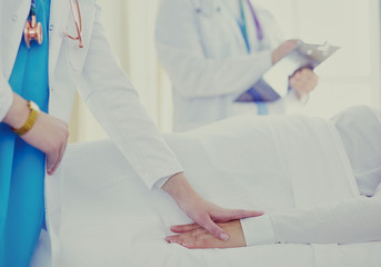 doctor or nurse talking to patient in hospital