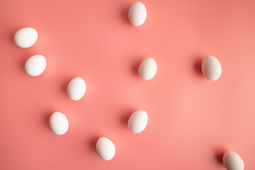 White eggs on pink background Easter concept flat lay