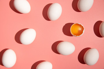 White eggs on pastel pink background. Easter holiday concept.