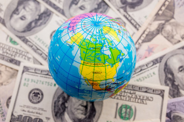 Globe on a pile of dollars planet earth