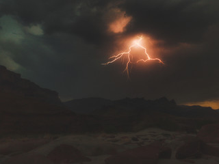 Lightning bolt flashing over Grand Canyon.  South Rim Desert View Watchtower in view.  From Tanner...