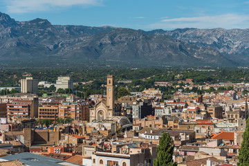 Fototapeta na wymiar View of city buildings on a background of mountains, Tortosa, Catalonia, Tarragona, Spain.