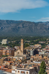 Fototapeta na wymiar View of city buildings on a background of mountains, Tortosa, Catalonia, Tarragona, Spain. Vertical.
