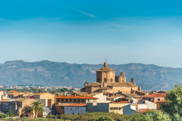 Fototapeta na wymiar Church on a background of mountain landscape, Ginestar, province Tarragona, Catalonia, Spain. Copy space for text.