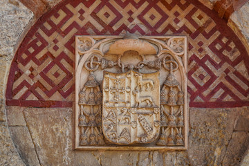 Coat of arms on the facade of the building Mosque Cathedral of Cordoba, Andalusia, Spain.
