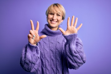 Young blonde woman with short hair wearing winter turtleneck sweater over purple background showing and pointing up with fingers number eight while smiling confident and happy.