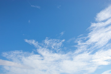 Naklejka na ściany i meble White fluffy clouds on bright blue sky