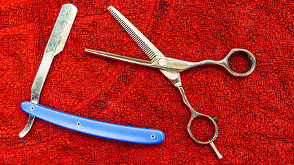Shaving and barber equipment on the red towel background.