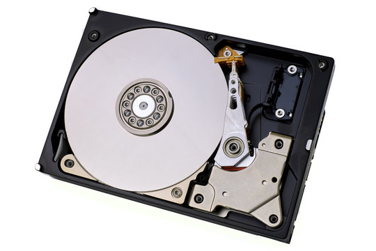 Hard disk drive isolated on white background. A computer's HDD data storage without protective cover, show the magnetic disk and electronic components inside the device.