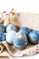 Easter atmosphere. Dyed Easter eggs and spring flowers on a white background. Easter atmosphere.