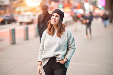 Young beautiful woman smiling happy and confident. Standing with smile on face walking at the city