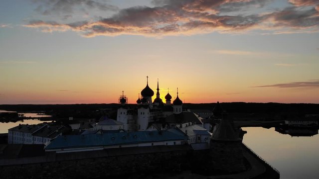Smooth cinematic flight over the Solovetsky monastery during a beautiful sunset. Solovetsky monastery is an old Russian Orthodox Church monastery, located on the White sea's Islands