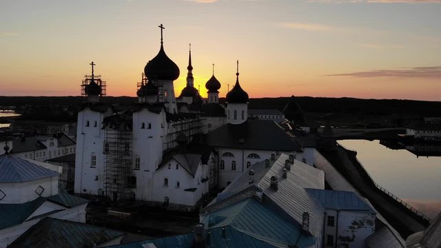 Smooth cinematic flight over the Solovetsky monastery during a beautiful sunset. Solovetsky monastery is an old Russian Orthodox Church monastery, located on the White sea's Islands