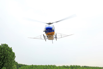 Agricultural helicopters fly in the sky
