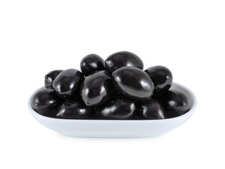 Large dried black olives with stone in oil in bowl isolated on white background   