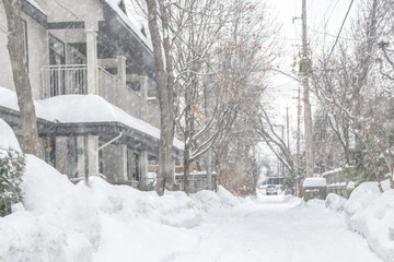 Fototapeta na wymiar Snow-clogged laneway street during snowstorm nobody