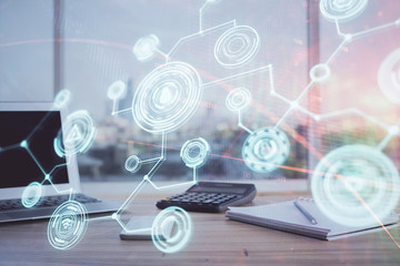 Computer on desktop with social network hologram. Multi exposure. Concept of international people connections.