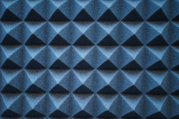 Foam material specifically for the walls of a recording studio. Soundproof and sound absorbing materials. Details, close-up of triangles wall decoration. Soft focus and shallow depth of field.