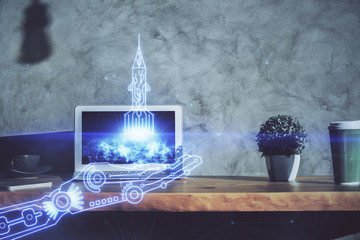 Desktop computer background in office and start up theme hologram drawing. Double exposure. Startup concept.