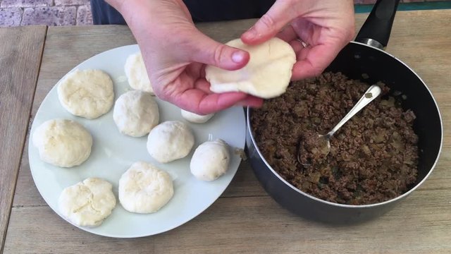 Woman preparing Kubbeh matfuniya Levantine dish