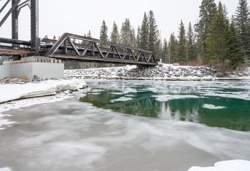 Snowy day at Engine Bridge pedestrian crossing over the Bow River in Canmore, Alberta, Canada