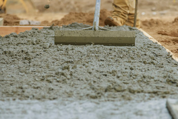 Cement pouring during sidewalk in new residential home - obrazy, fototapety, plakaty