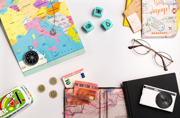 Top view of Traveler accessories: map, compass, camera, notebook, passport, money, letters, etc.