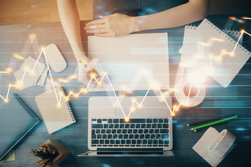 Financial graph displayed on woman's hand taking notes background. Concept of research. Multi exposure