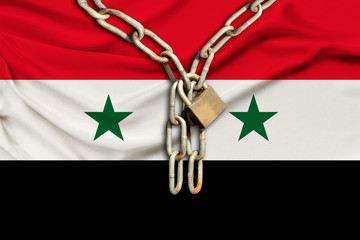iron chain and lock on the silk national flag of Syria with beautiful folds, the concept of a ban...