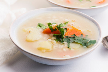 Barley soup, pearl barley in white bowl