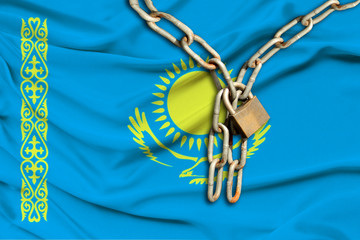 iron chain and lock on the silk national flag of Kazakhstan with beautiful folds, the concept of a...