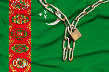 iron chain and lock on silk national flag of Turkmenistan with beautiful folds, the concept of a...