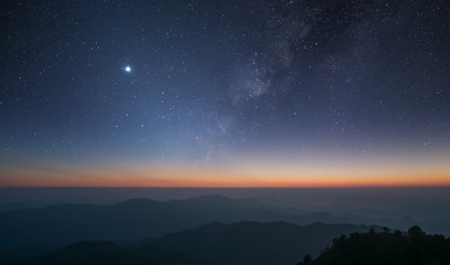 Naklejka na ściany i meble Stars and the Milky Way in the dark night sky are very beautiful.