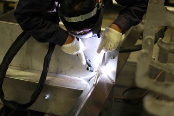 Metal workers use manual labor. Skilled welder. Factory workers making OT. Welder is welding the steel in the factory. welder Industrial automotive part in factory.